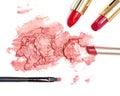 Smeared lipstick with makeup brush on white background