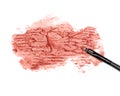 Smeared lipstick orange color with makeup brush