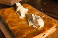 Smearing the cream over the layers of cake dough. Pie filling