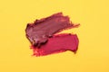 Smears of bright lipsticks on yellow background, top view Royalty Free Stock Photo
