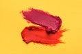 Smears of bright lipsticks on yellow background, top view Royalty Free Stock Photo