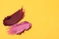 Smears of bright lipsticks on yellow background, top view. Space for text Royalty Free Stock Photo