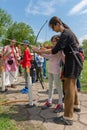 Children learn to shoot with a bow and arrow.