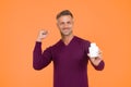 Smell good all day. Happy guy hold cologne bottle. Personal hygiene. Handsome man presenting hygiene product. Lotion and Royalty Free Stock Photo