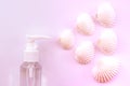 The smell of the sea. Plastic perfume spray bottle with shells on  pastel pink background. Royalty Free Stock Photo