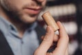 Smell of wine cork in hands of sommelier, sample aging drink