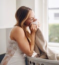 Smelling, woman and laundry with clothes in basket and happy with clean apartment towel. Female person, cleaning or