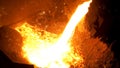 Smelting of the metal in the foundry at the steel mill. Stock footage. Close up for hot steel being poured from the Royalty Free Stock Photo