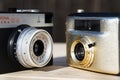 Smena 8M and Penti I old vintage golden cameras on wooden background