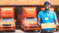 Smile african man postal delivery courier man in front of car delivering package Royalty Free Stock Photo