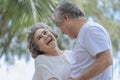 Smile asian senior retired couple, relax smiling elder man and woman enjoying with retired vacation at sea beach outdoor. Health Royalty Free Stock Photo