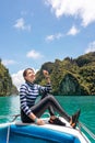 Smile asian woman posing in swimming suit sitting on the yacht at beautiful sea , Phi phi island thailand Royalty Free Stock Photo