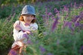 smile Asian young woman at Salvia leucantha bush field garden Royalty Free Stock Photo