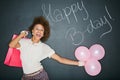 Smile, birthday balloons and portrait of a black woman with a gift and chalkboard for celebration. Happy, smile and Royalty Free Stock Photo