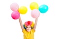 Smile boy in clown wig holds hands up with balloons Royalty Free Stock Photo