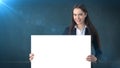 Smile Business woman portrait with blank white board on blue isolated. Female model with long hair. Royalty Free Stock Photo