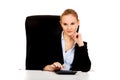 Smile business woman using calculator behind the desk Royalty Free Stock Photo
