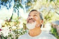 Smile, calm and senior man in nature breathing for fresh air, peaceful or mindful attitude in a garden. Happy, wellness Royalty Free Stock Photo