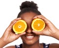 Smile, child and fruit with girl and orange in studio for nutrition, wellness and diet. Food, self care and vitamin c