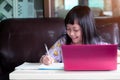 Smile child girl studying homework during her online lesson at home for protect 2019-nCoV or Covid 19 , online education Royalty Free Stock Photo