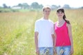 Smile couple hold hands in field