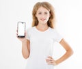 Smile cute girl, woman in tshirt hold blank screen cell phone isolated on white background. Arm holding smartphone, copy space Royalty Free Stock Photo