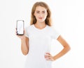 Smile cute girl, woman in tshirt hold blank screen cell phone isolated on white background. Arm holding smartphone, copy space Royalty Free Stock Photo