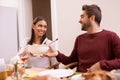 Smile, dinner and couple at table with salad, food, and drinks for celebration in home. Social event, man and woman at Royalty Free Stock Photo