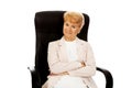 Smile elderly business woman sitting on armchair Royalty Free Stock Photo