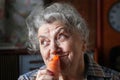 Smile elderly woman eating carrot Royalty Free Stock Photo