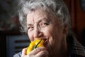 Smile elderly woman eating pepper Royalty Free Stock Photo