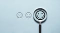 Smile face icon inside magnifier glass for customer excellent evaluation and feedback survey after use product and service concept Royalty Free Stock Photo