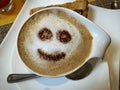 Smile face shape of hot cappuccino coffee