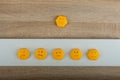 smile-faced group of sad emojis against the background of a wooden table. Be positive. Royalty Free Stock Photo