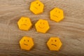 smile-faced group of sad emojis against the background of a wooden table. Be positive. Royalty Free Stock Photo