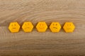 smile-faced group of sad emojis against the background of a wooden table. Be positive. Royalty Free Stock Photo