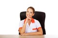 Smile female doctor or nurse sitting behind the desk Royalty Free Stock Photo
