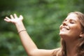 Smile, freedom and a woman arms raised in a forest for mental health, wellness or zen meditation. Summer, nature and a