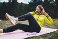 Smile girl exercising outdoors in green park, activity pose with stretch legs, happy woman laughing stretching exercises training Royalty Free Stock Photo