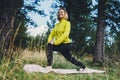 Smile girl exercising outdoors in green park, activity with stretch legs. Young fitness woman doing stretching exercises training Royalty Free Stock Photo