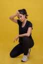 Smile happy Beautiful Asian Young fitness sport woman is resting tired sweat and stretching exercise workout on yellow background Royalty Free Stock Photo