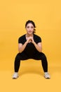 Smile happy Beautiful portrait young Asian woman stretching exercise workout on yellow background, fitness sport girl aerobic and Royalty Free Stock Photo