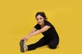 Smile happy Beautiful portrait young Asian woman stretching exercise workout on yellow background, fitness sport girl aerobic and Royalty Free Stock Photo
