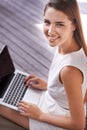 Smile, laptop and portrait of woman outdoor by pier working on creative project online with fresh air. Happy, technology Royalty Free Stock Photo