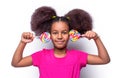 Smile little american girl eating lollipop, holding pink sweet colorful lollipop candy, sweets. Cute small girl smiling Royalty Free Stock Photo