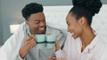 Smile, love and happy black couple drink a cup of coffee on a bed in the morning at home. People in loving, smiling in Royalty Free Stock Photo