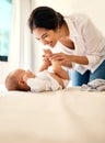 Smile, love and a mother with her baby in the bedroom of their home together for playful bonding. Family, kids and a Royalty Free Stock Photo
