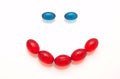 Smile made of blue and red capsules