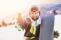 Smile man with snowboard take selfie photo background ski resort sunset. Concept banner winter travel, Sheregesh Royalty Free Stock Photo