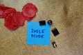 Smile More write on sticky notes isolated on Wooden Table